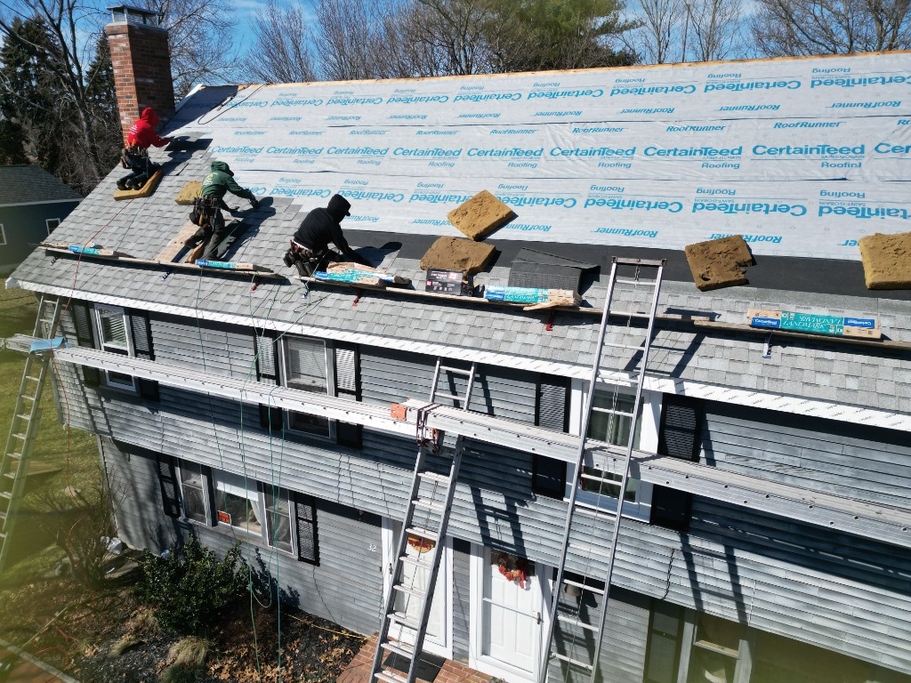 E&B Roofing Crew Installing Shingles